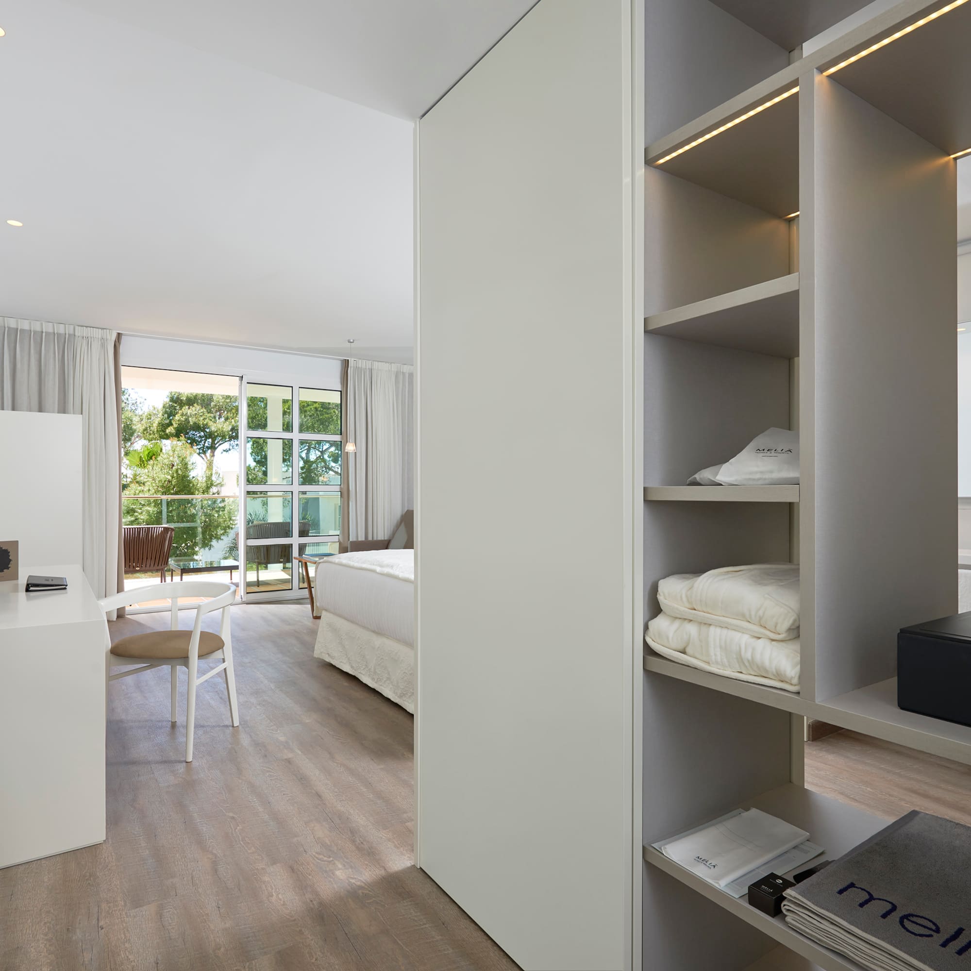 a room with a desk and shelves