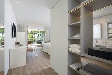 a room with a desk and shelves