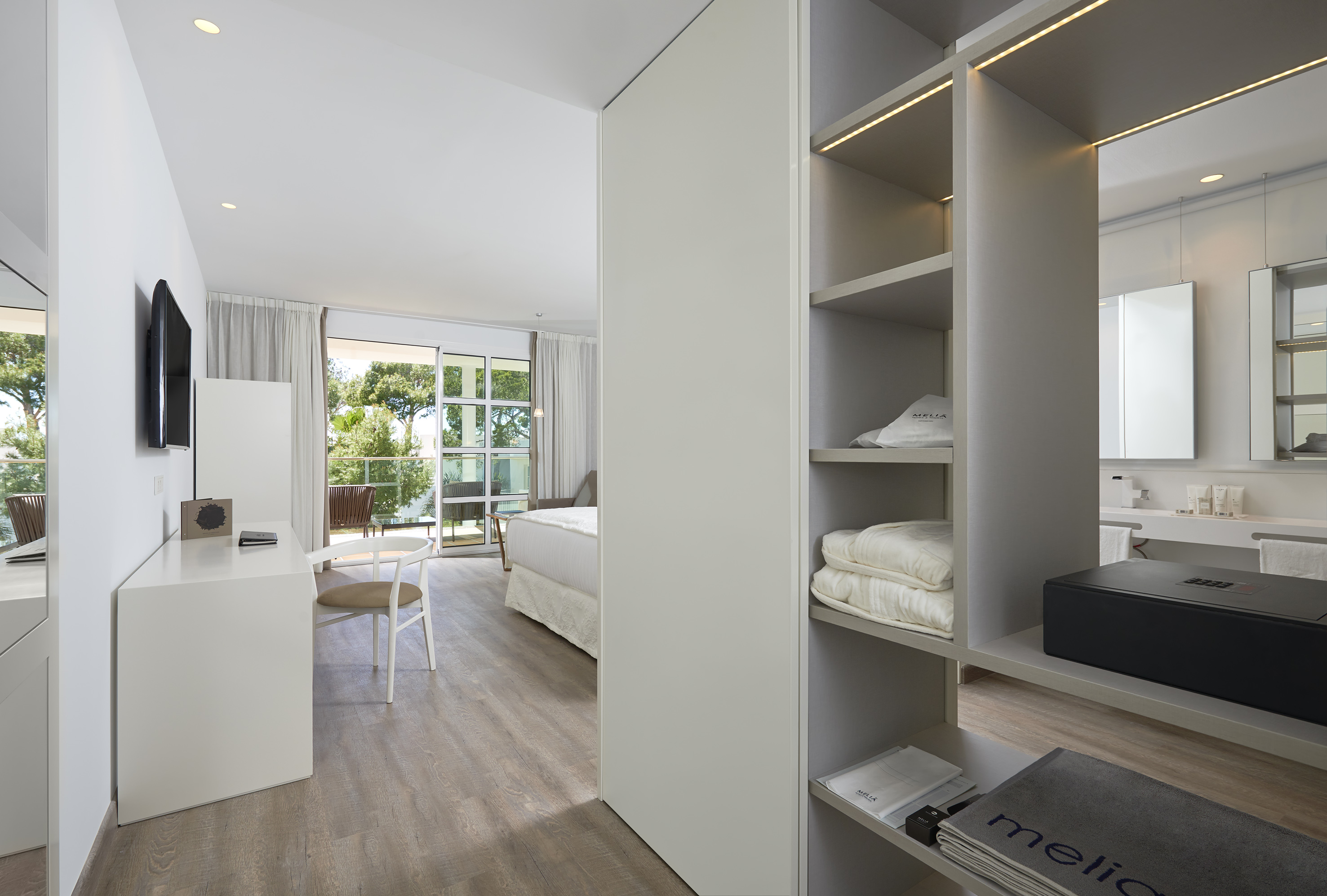 a room with a desk and shelves