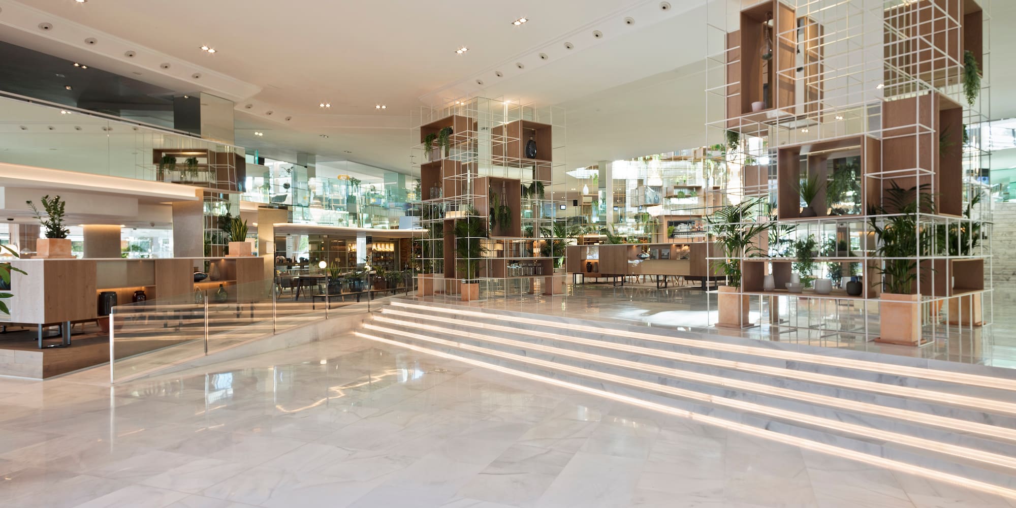 a large room with stairs and glass walls