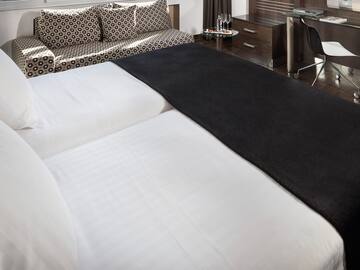 a bed with a black blanket on it