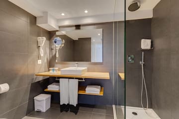a bathroom with a shower and sink