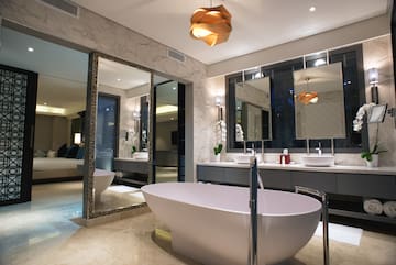 a bathroom with a tub and sinks