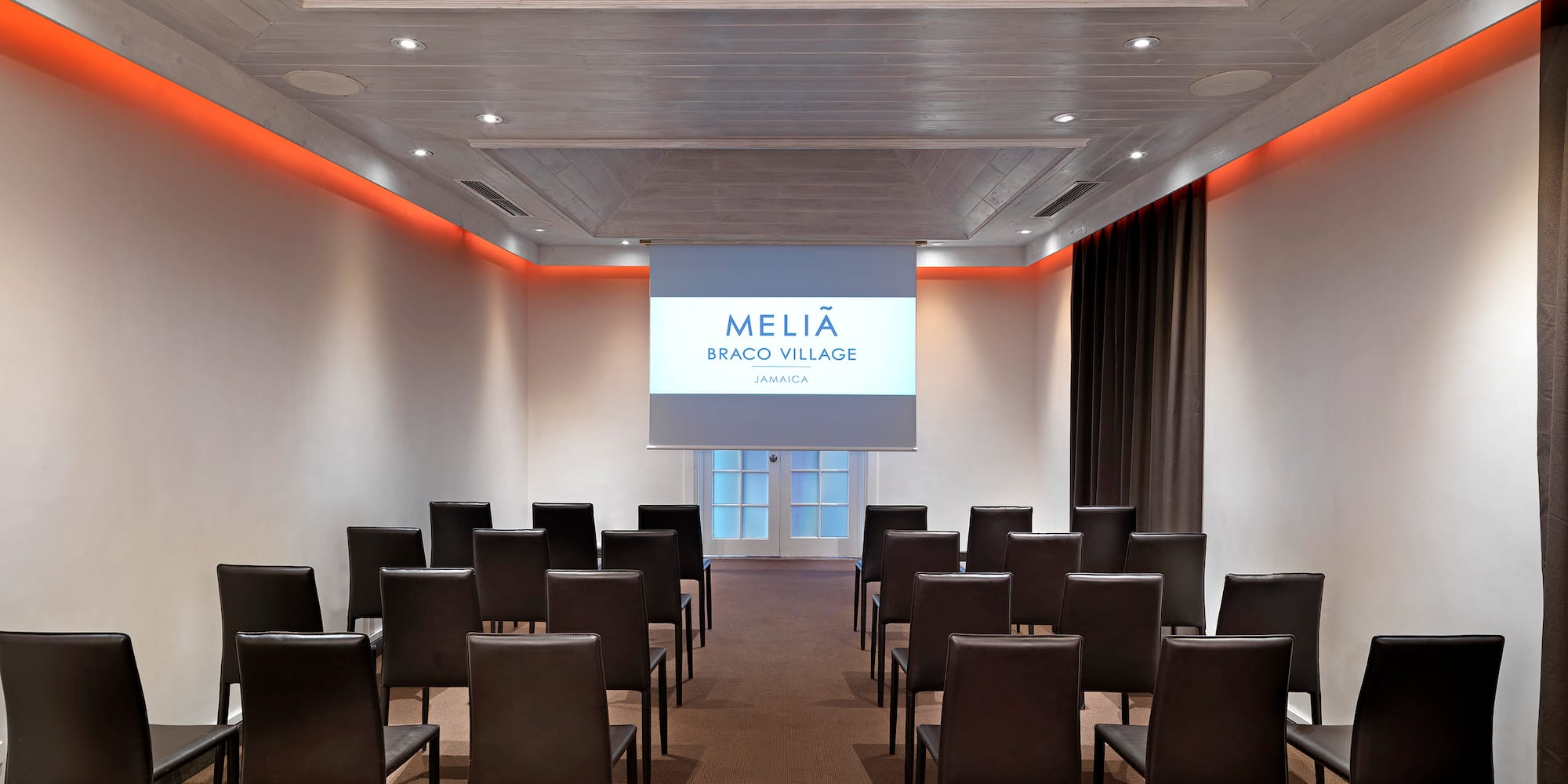 a room with chairs and a projector screen