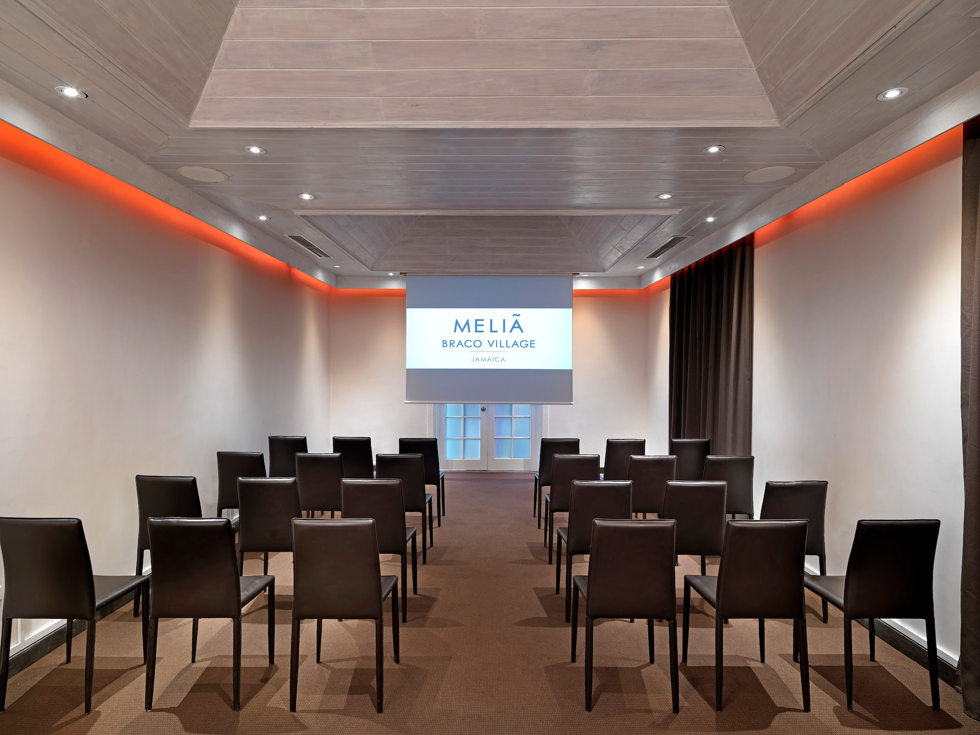 a room with chairs and a projector screen