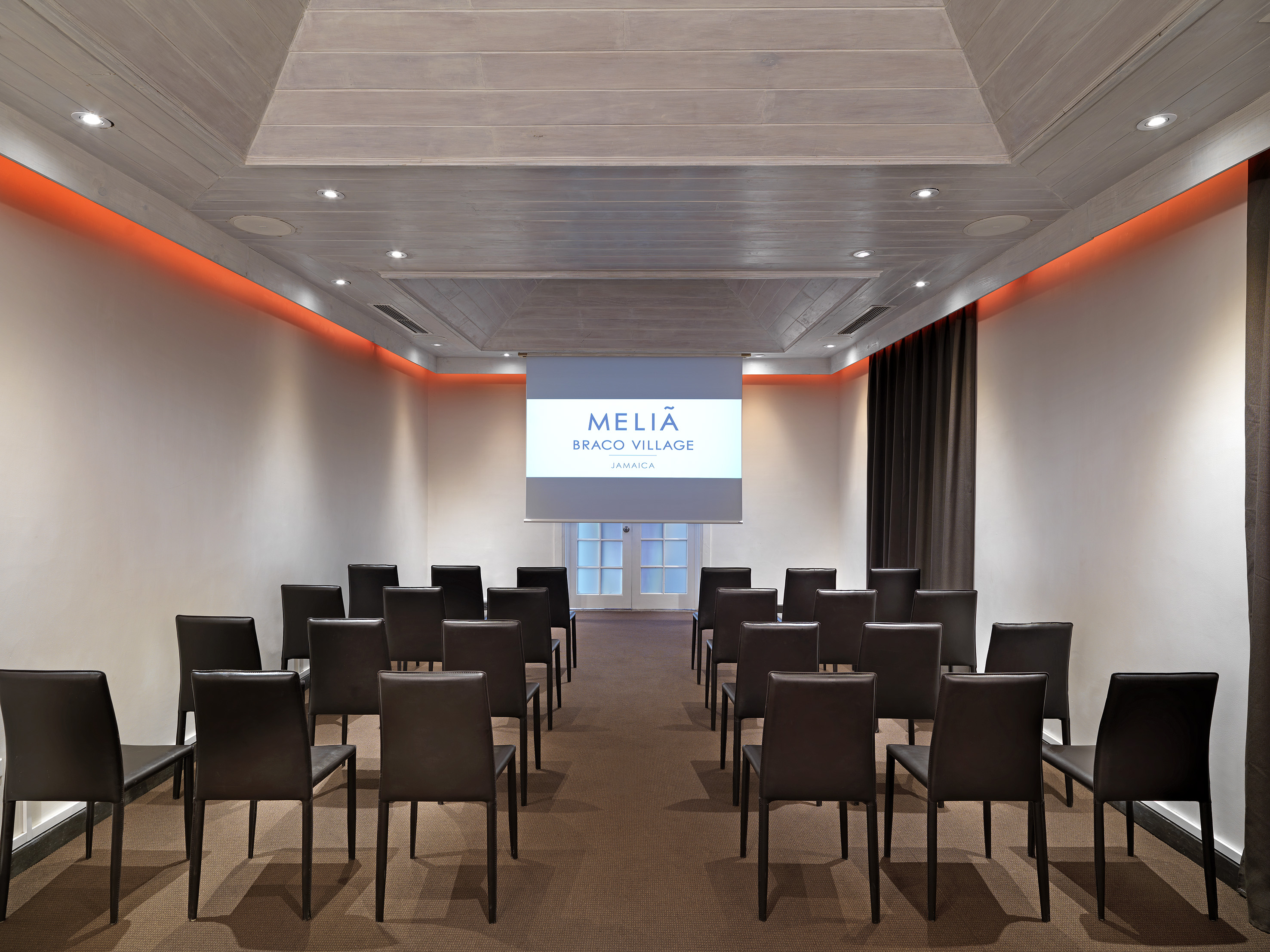 a room with chairs and a projector screen