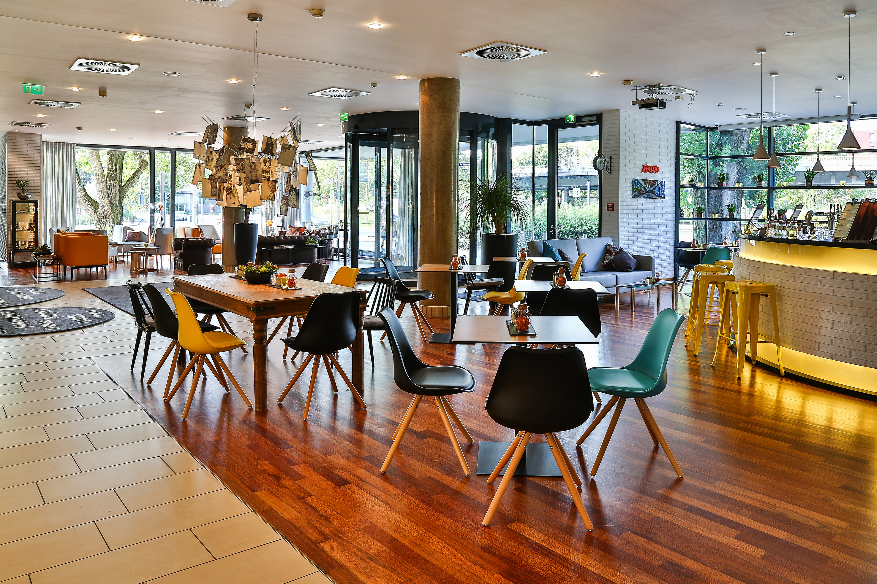 Modern hotel lobby restaurant with stylish chairs, bar, and lounge seating.