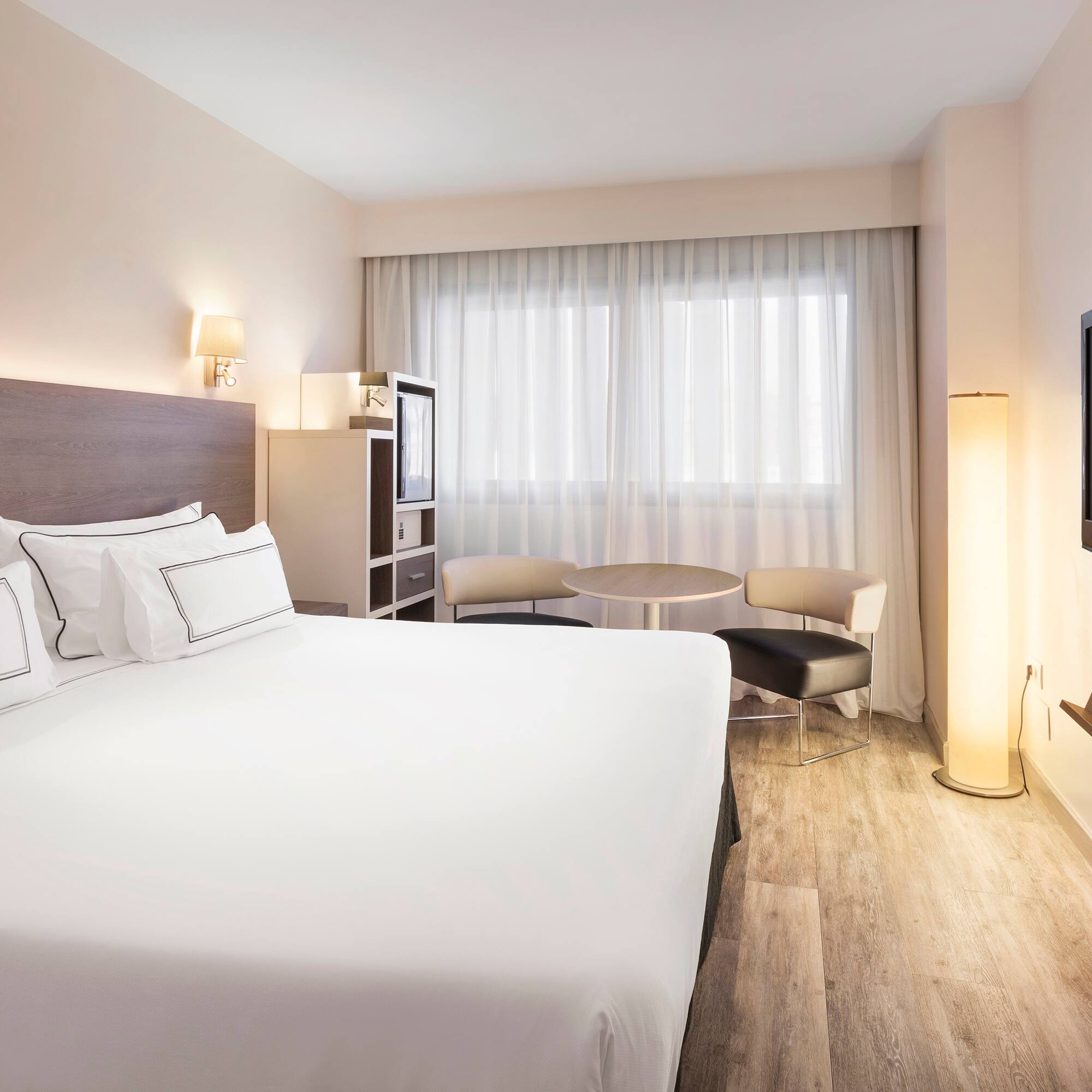 a room with a bed and a television