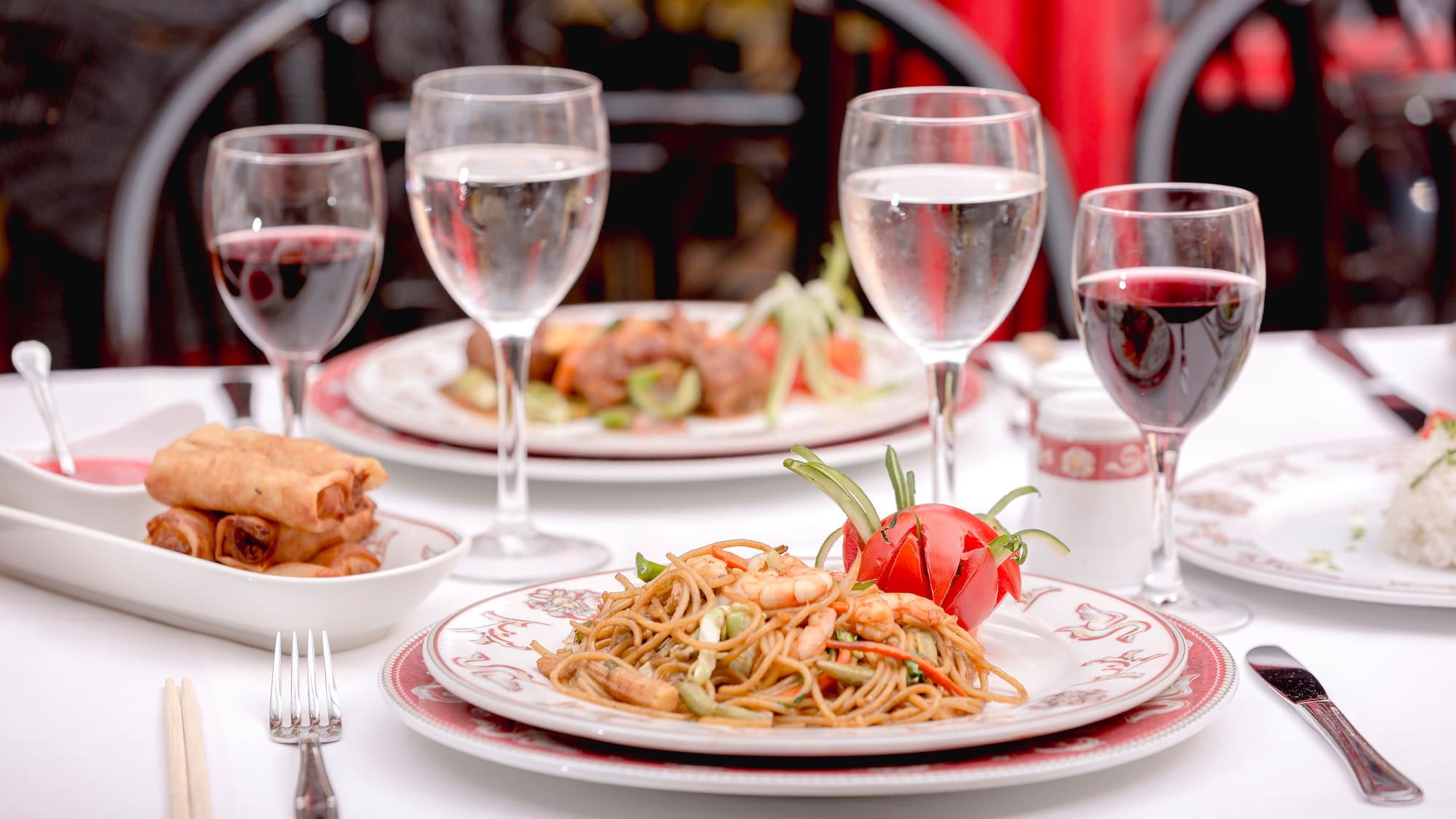 a plate of food and wine glasses on a table