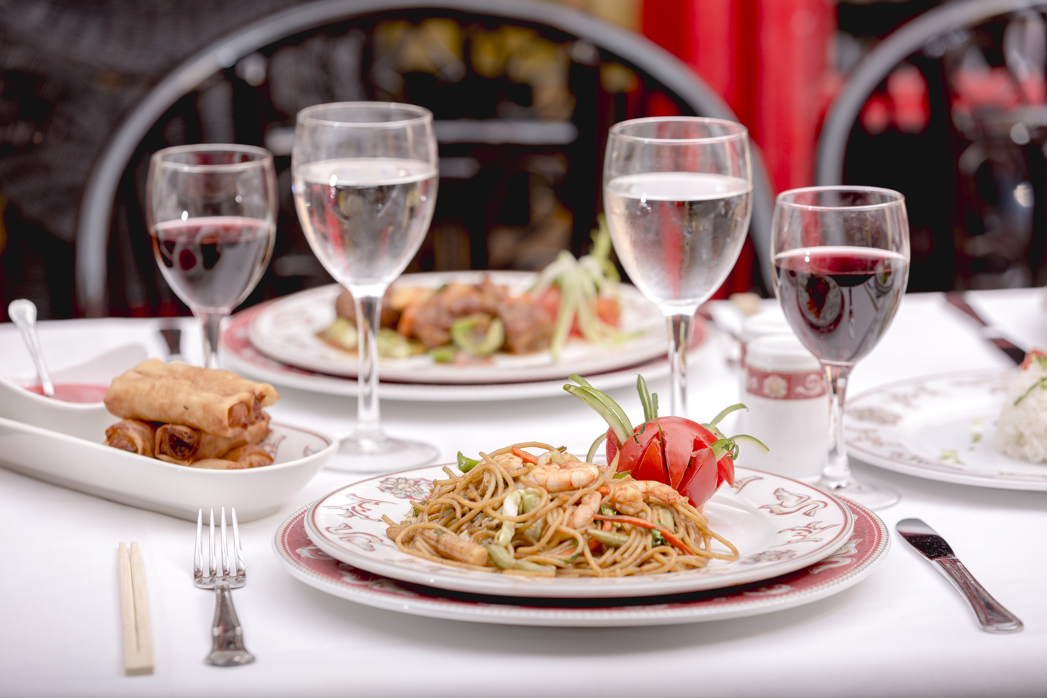 a plate of food and wine glasses on a table