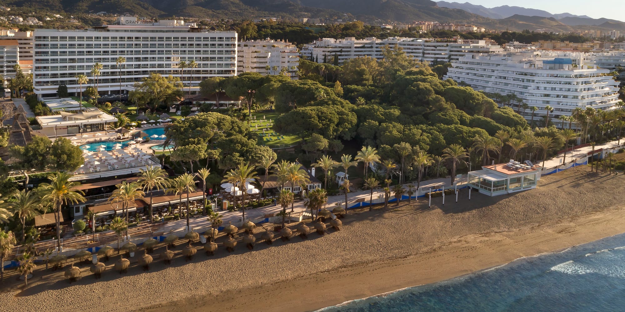 a beach with a body of water and buildings