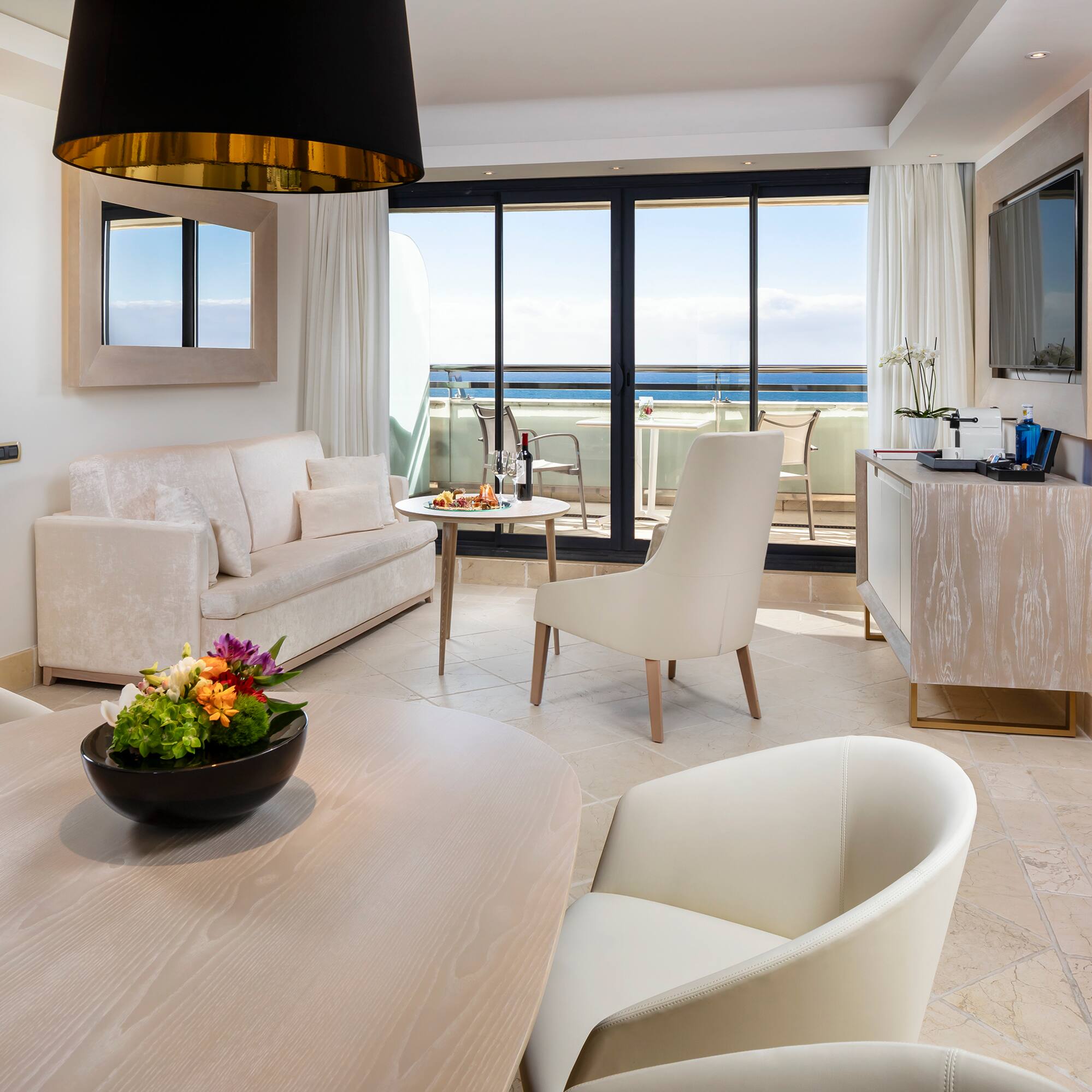 a room with a table and chairs and a television