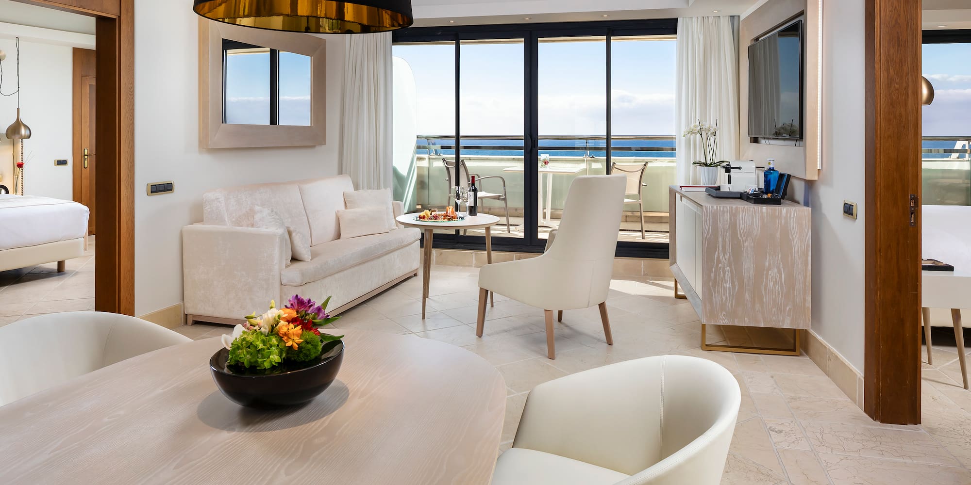 a room with a table and chairs and a television