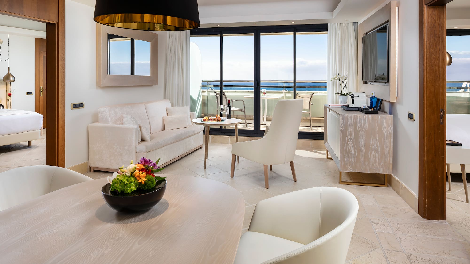 a room with a table and chairs and a television