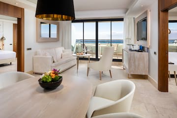 a room with a table and chairs and a television