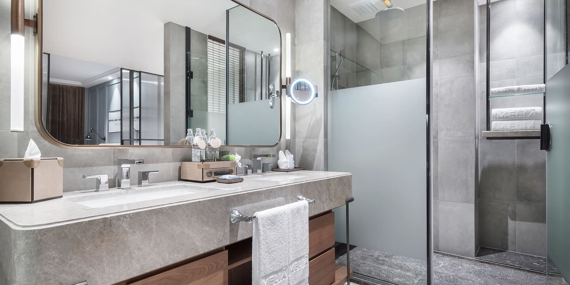 a bathroom with a large mirror and a shower