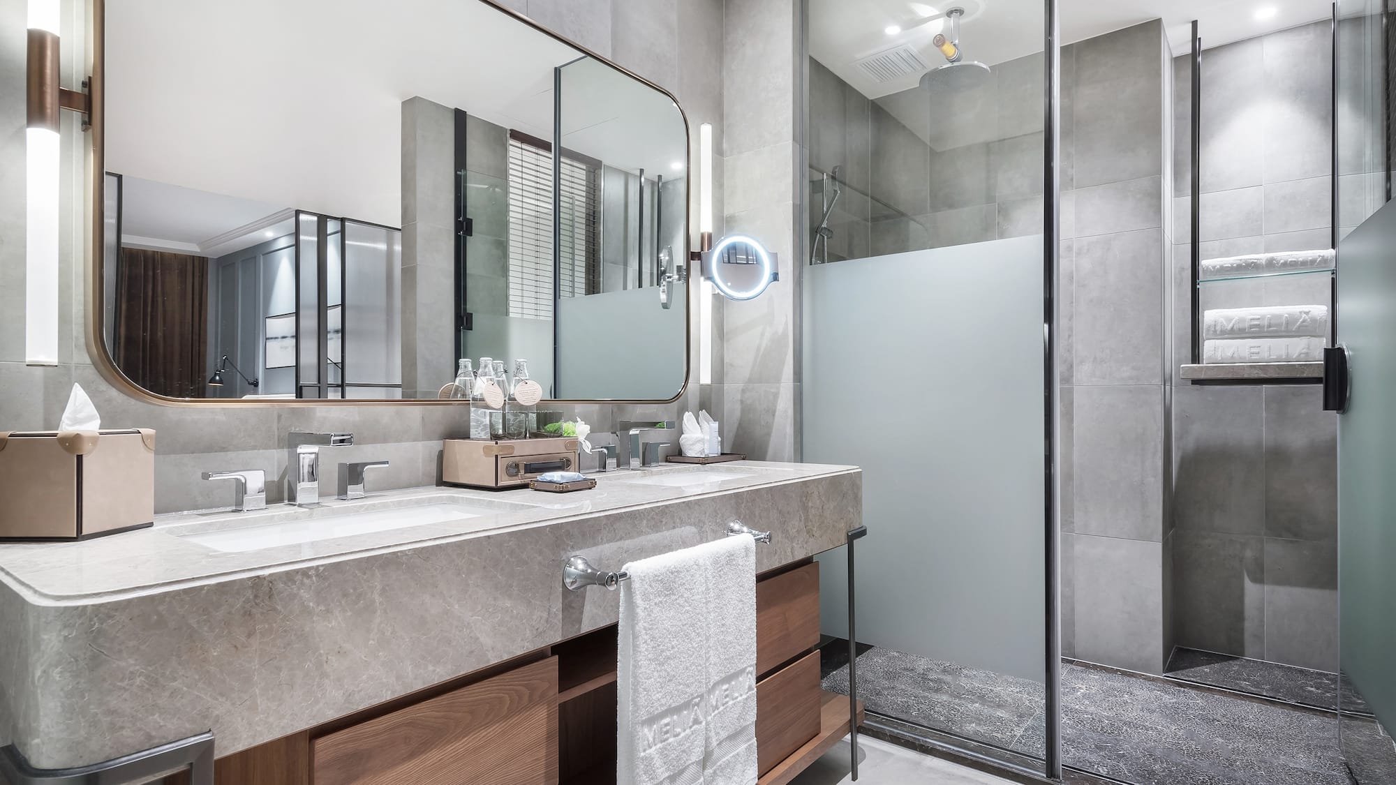 a bathroom with a large mirror and a shower