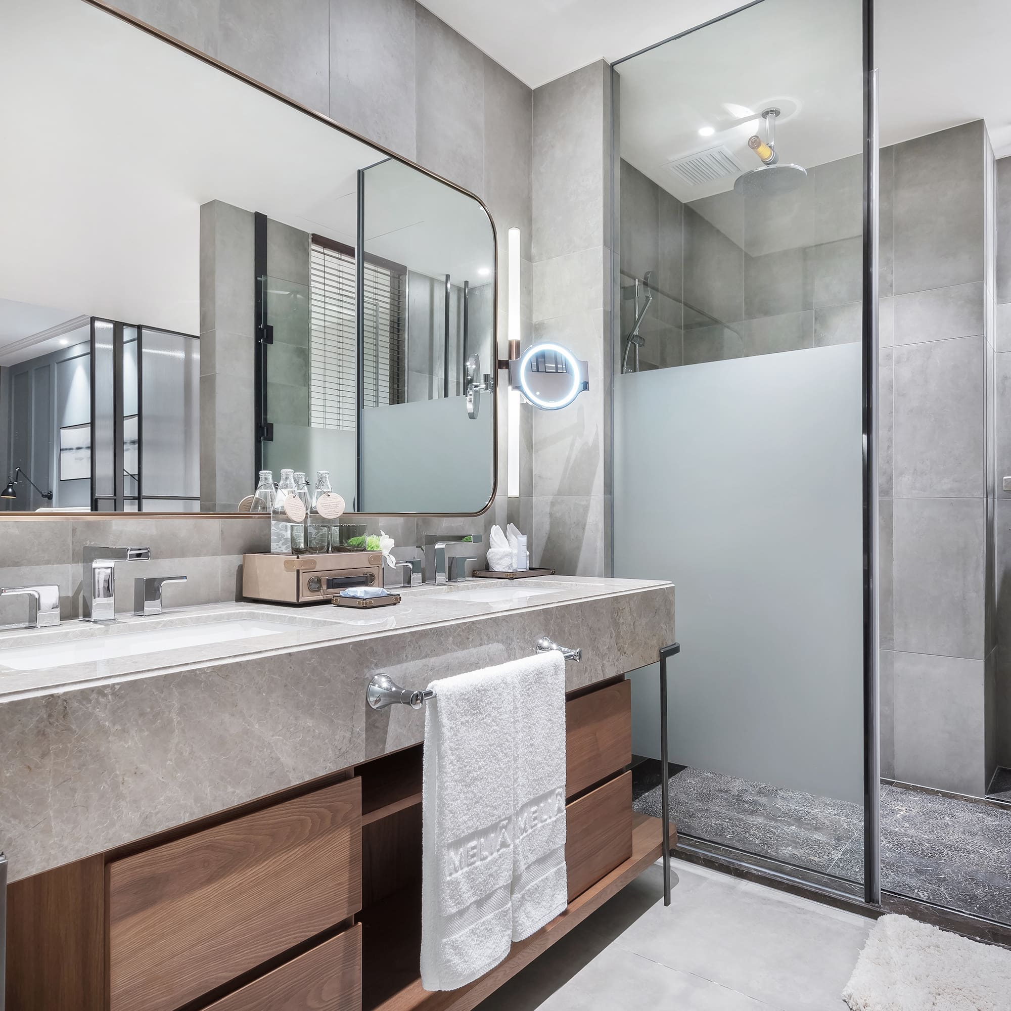 a bathroom with a large mirror and a shower