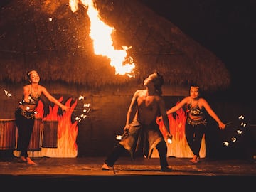 a group of people on a stage with fire