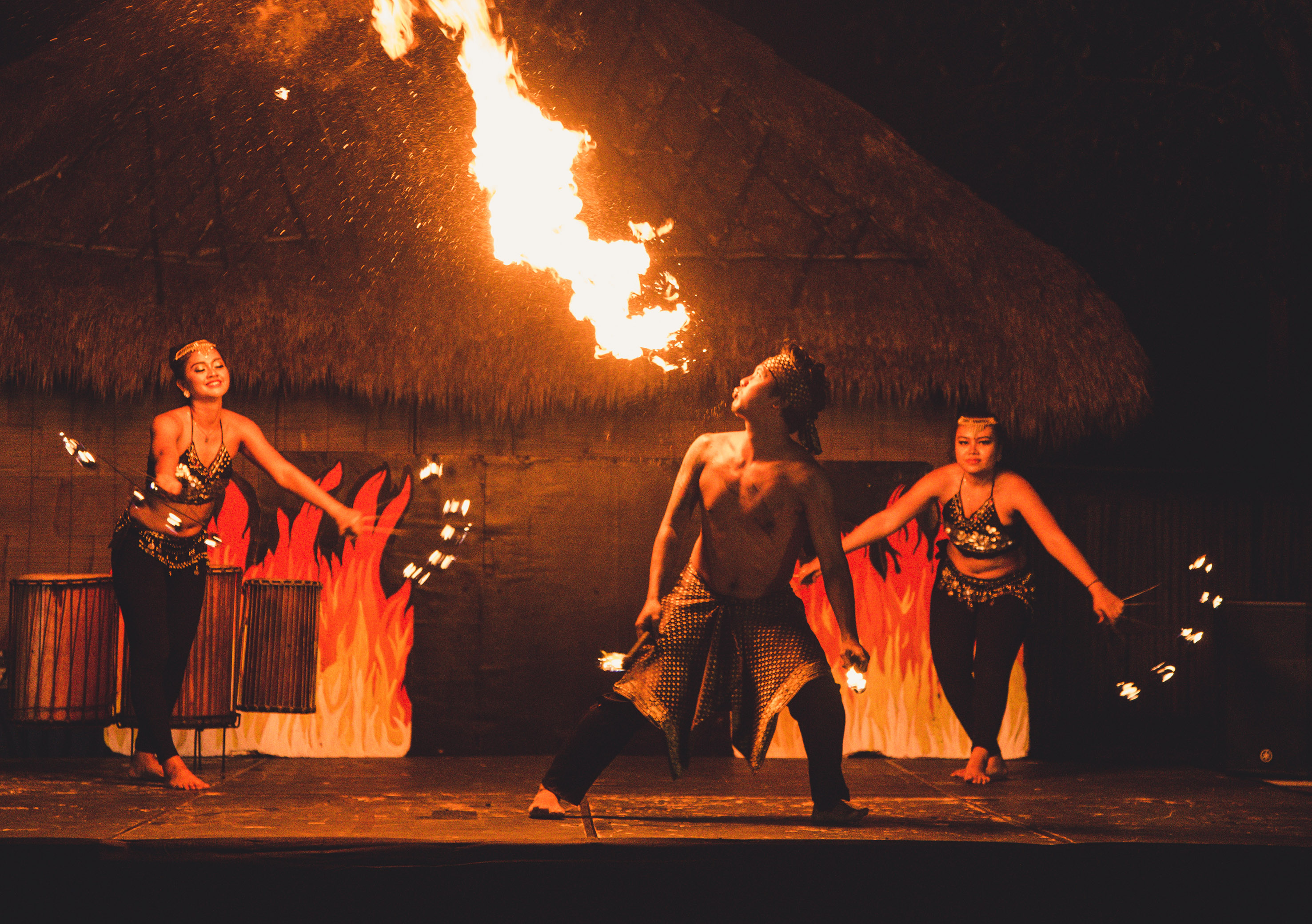 a group of people on a stage with fire