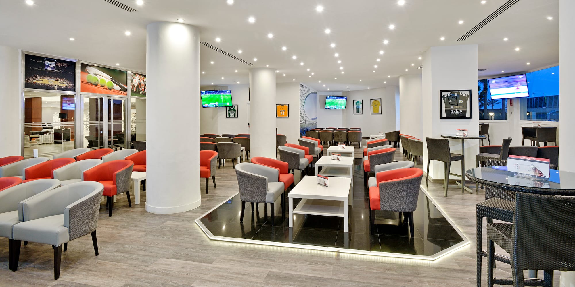 a room with white columns and tables and chairs