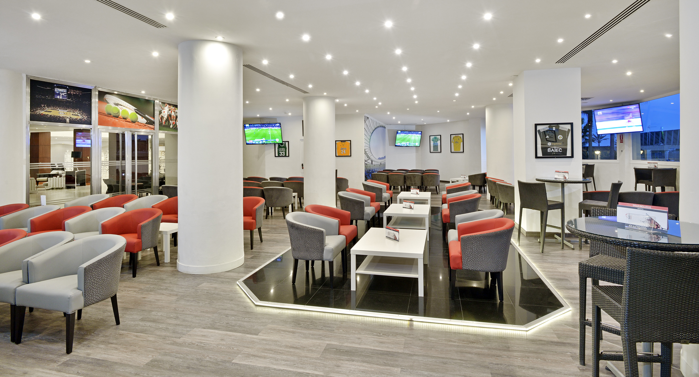 a room with white columns and tables and chairs