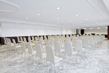 a room with white chairs