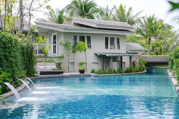 a pool with a house and trees