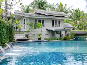 a pool with a house and trees