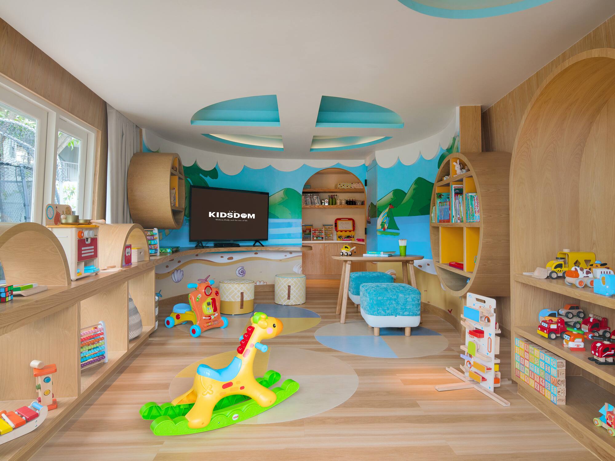 a room with a toy horse and bookshelves