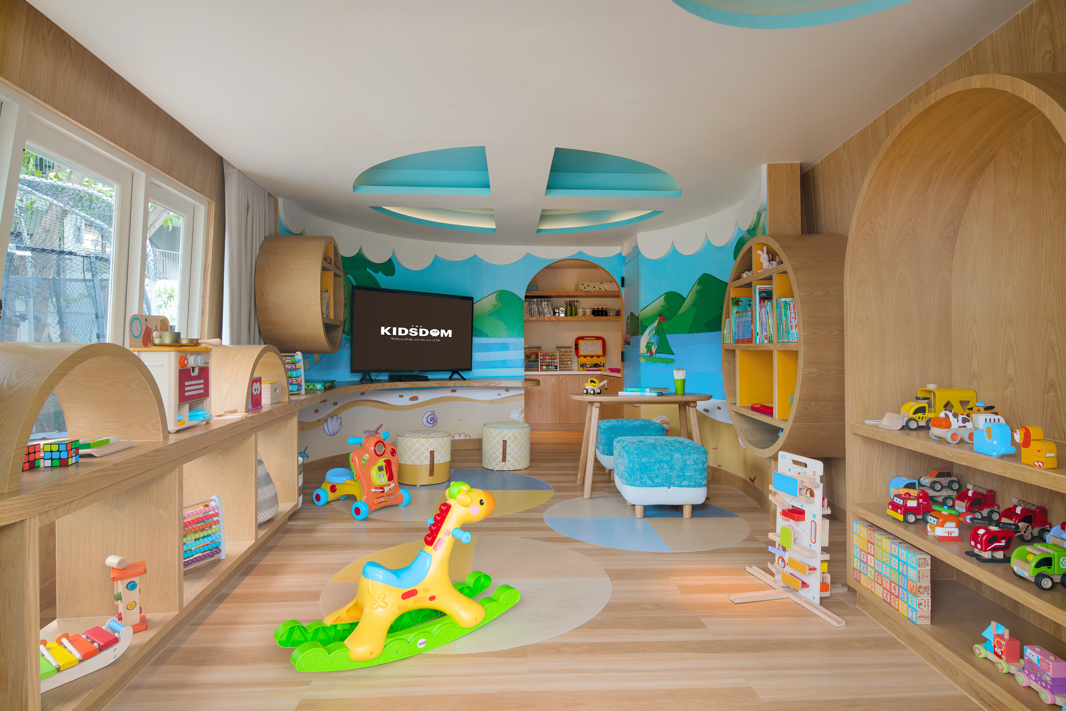 Bright kids playroom with wooden shelves, colorful toys, and a rocking horse.