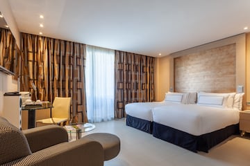 a room with two beds and a table