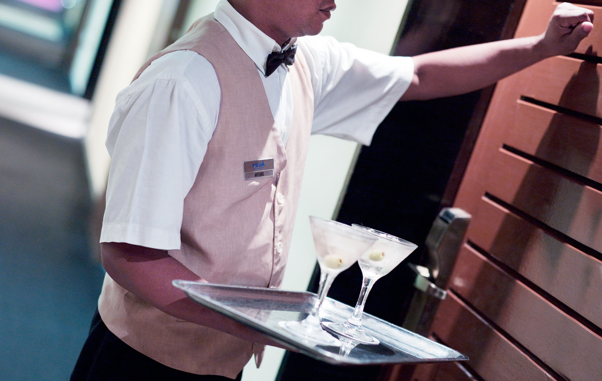 a waiter holding a tray with drinks