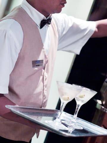 a waiter holding a tray with drinks