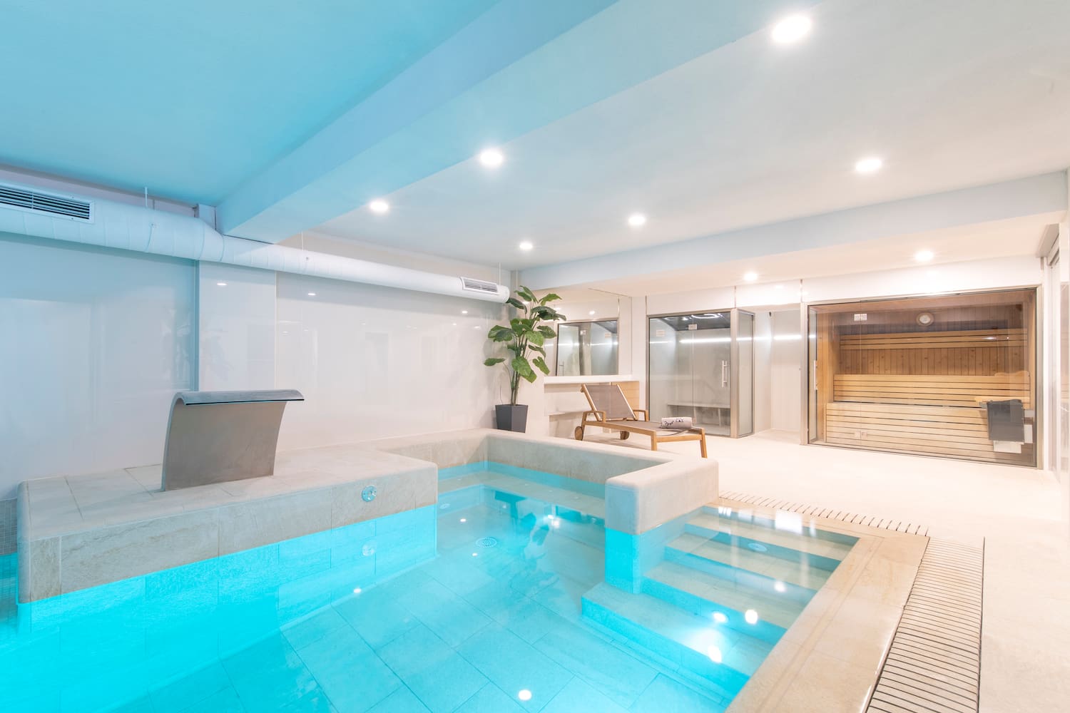 a indoor pool with a jacuzzi