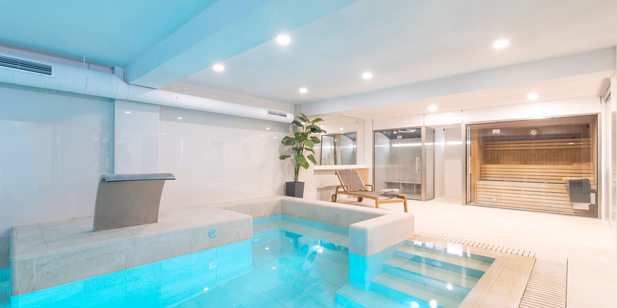 a indoor pool with a jacuzzi