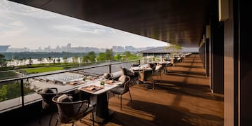 a restaurant with tables and chairs on a deck