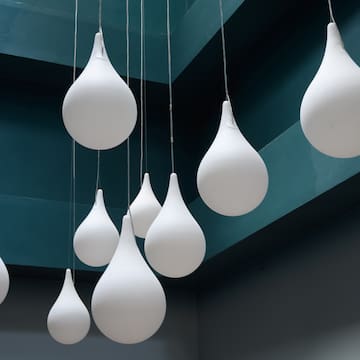 a group of white balloons from a ceiling