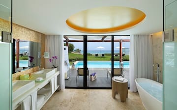 a bathroom with a pool and a tub