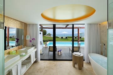 a bathroom with a pool and a tub