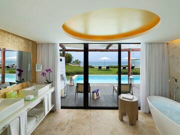 a bathroom with a pool and a tub