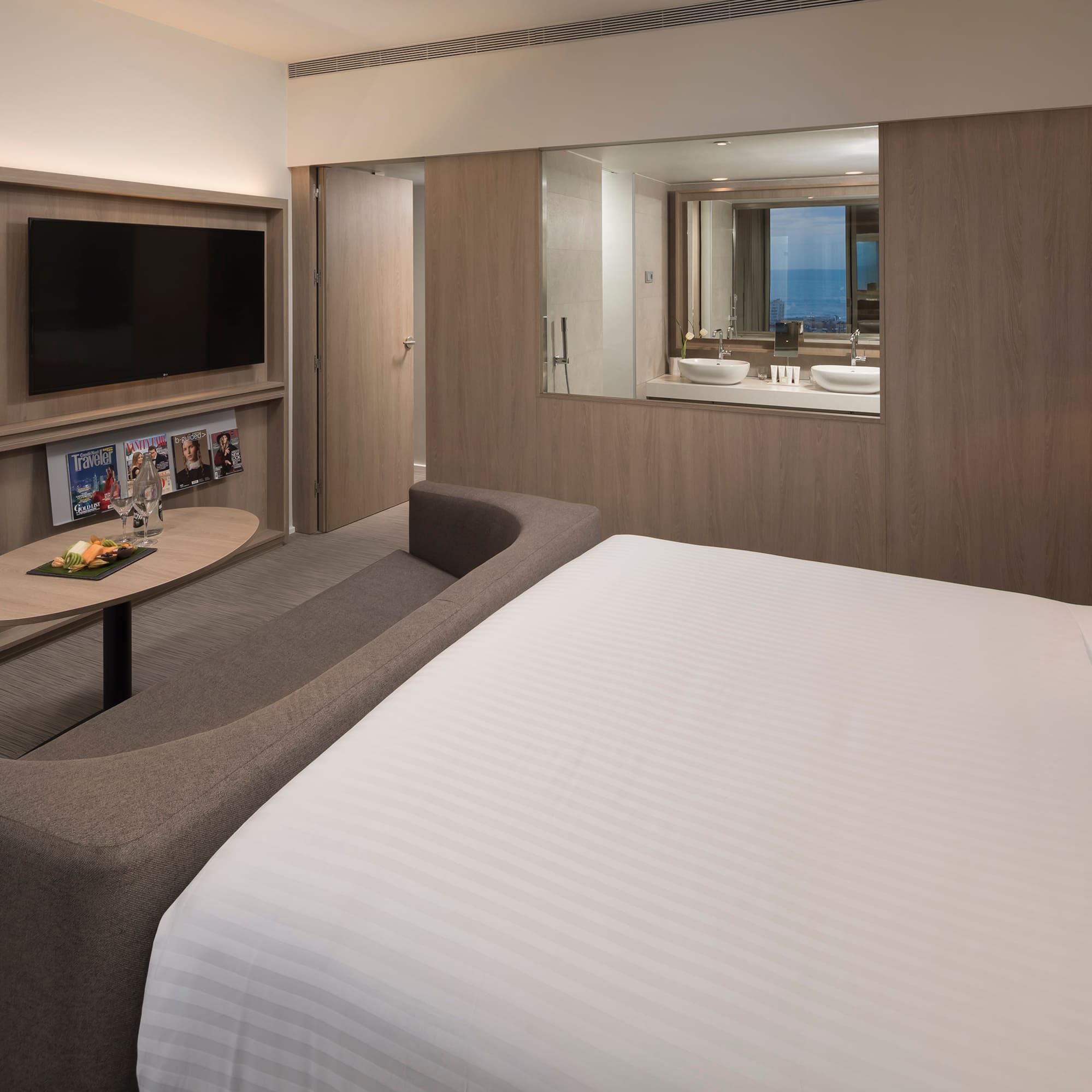 a room with a bed and a television