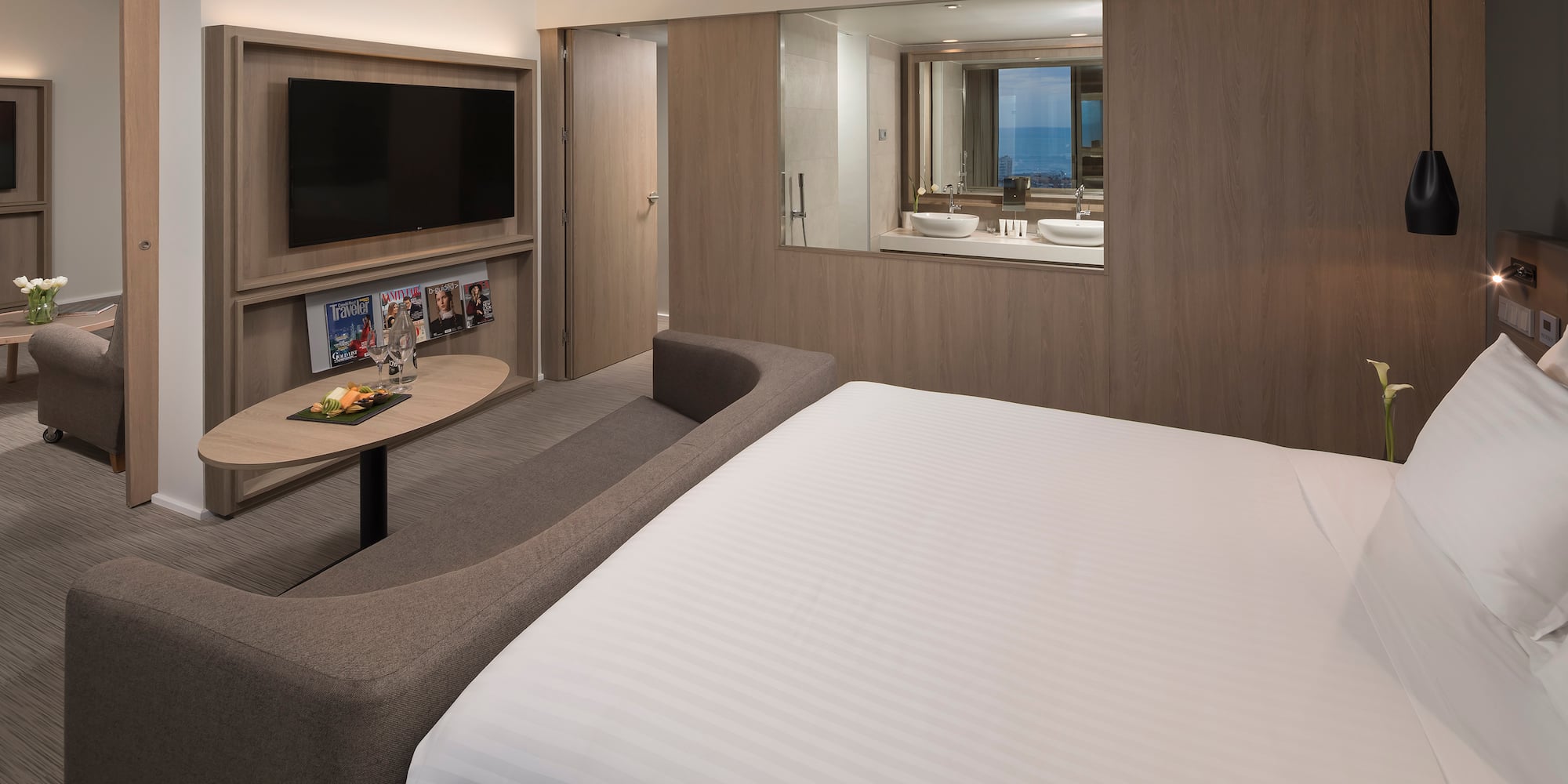 a room with a bed and a television