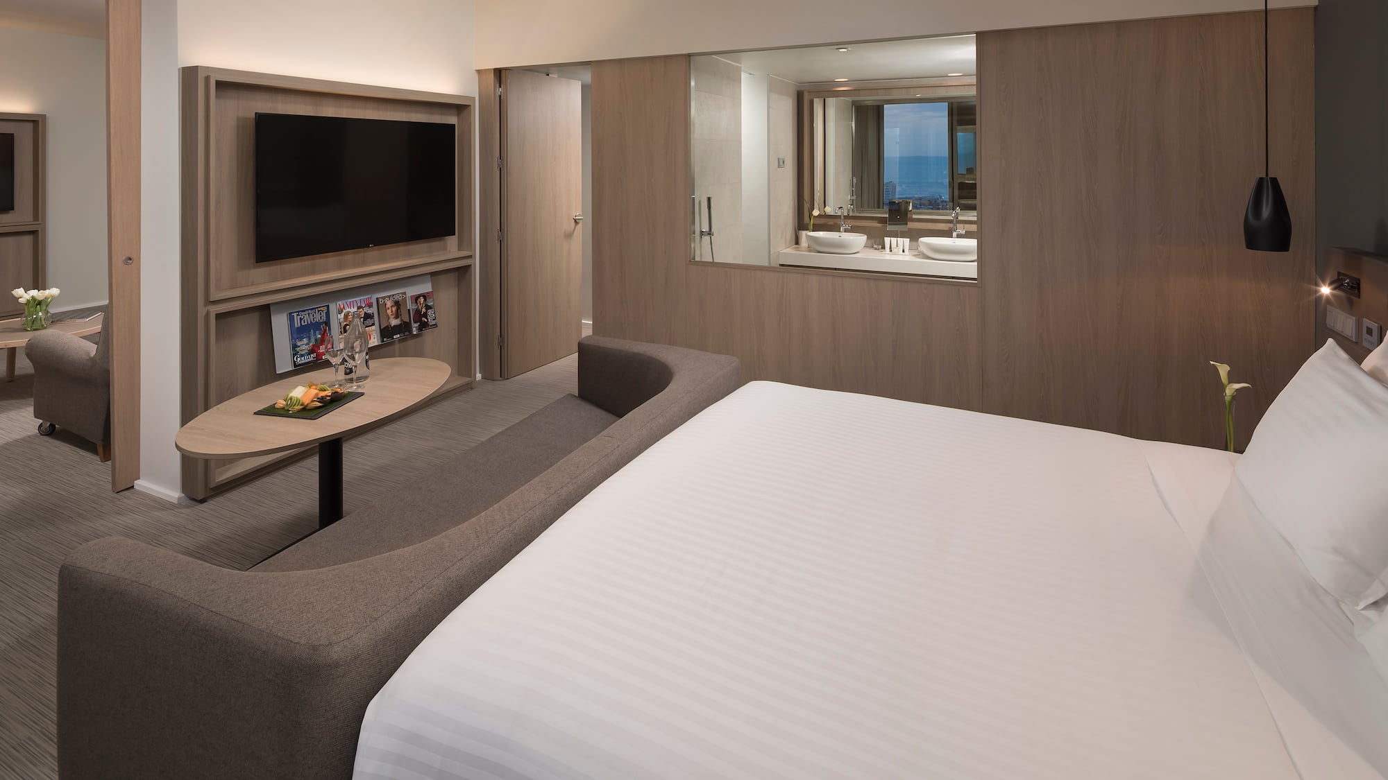 a room with a bed and a television