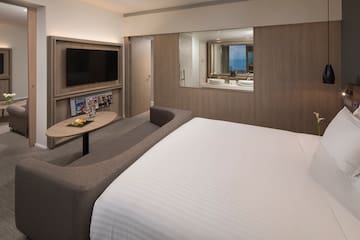 a room with a bed and a television