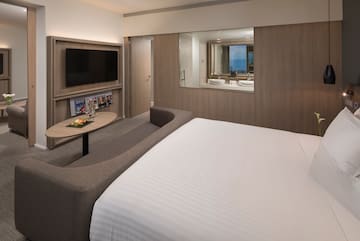 a room with a bed and a television