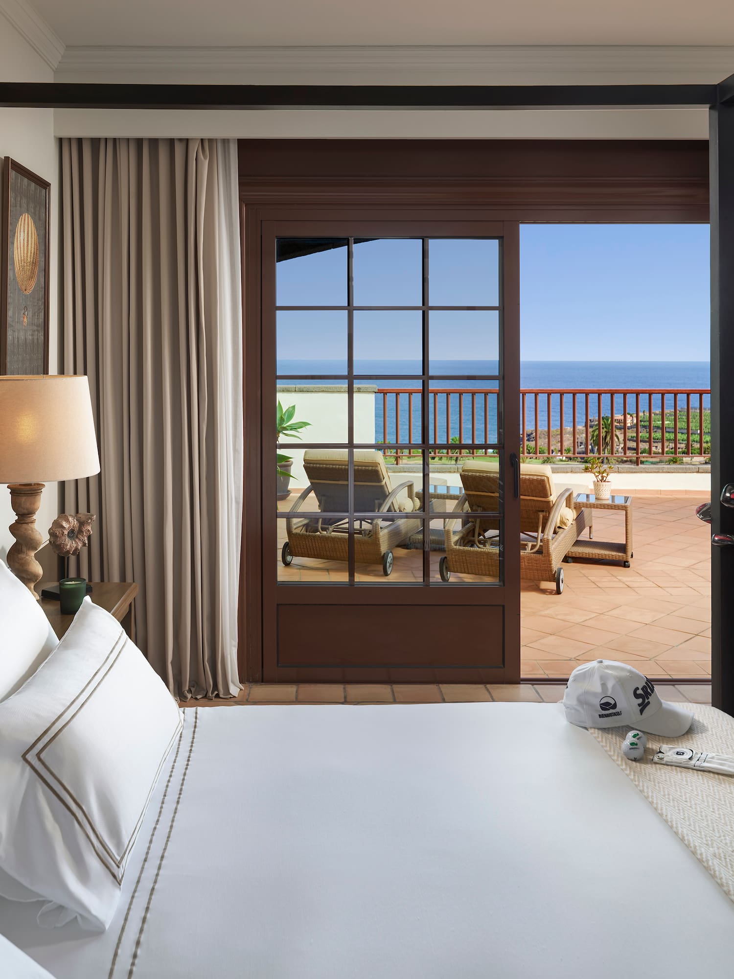 a bedroom with a large bed and a golf club