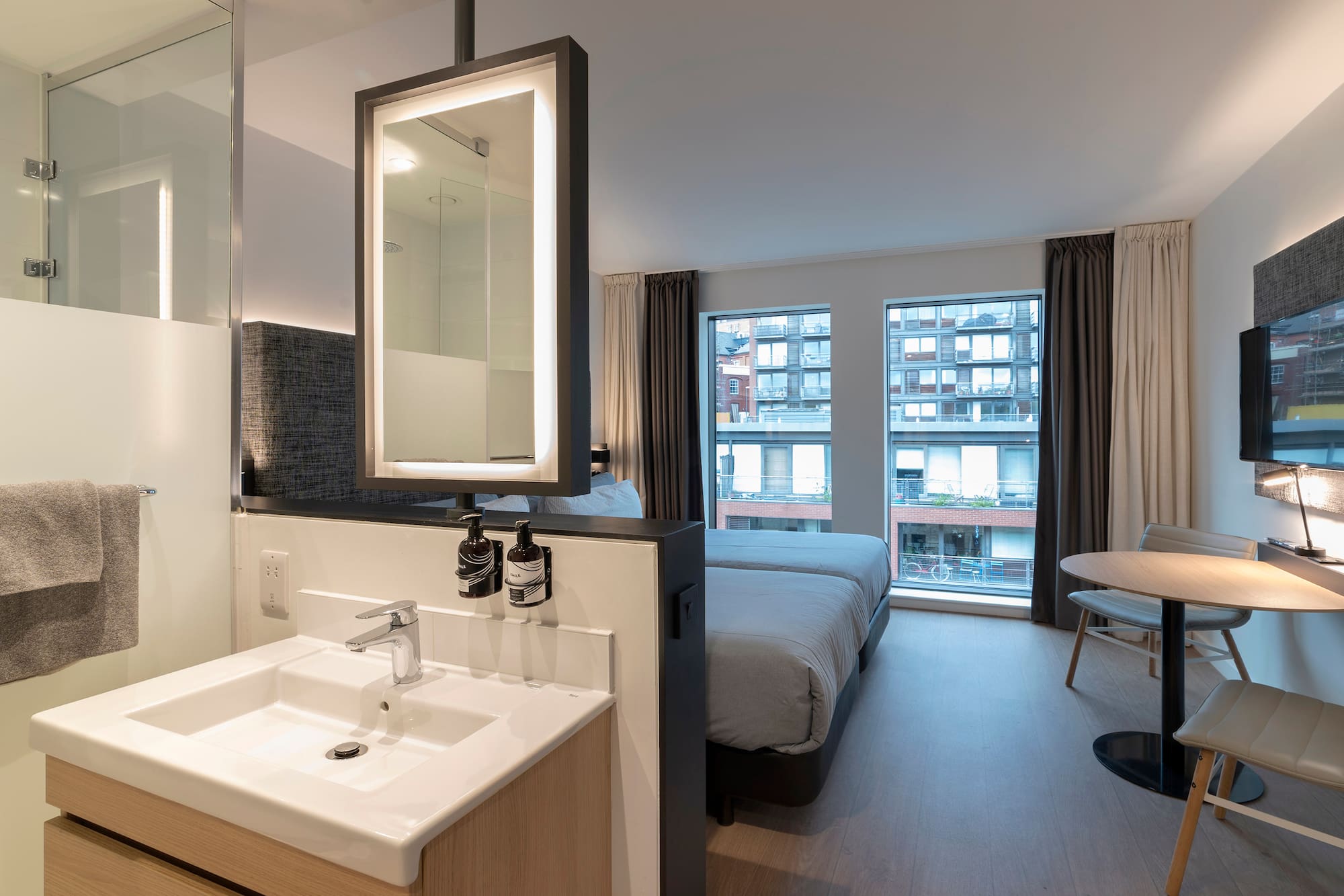 a bathroom with a bed and sink