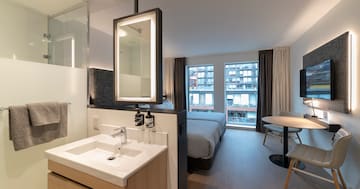 a bathroom with a bed and sink