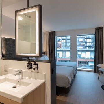 a bathroom with a bed and sink